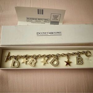 Dooney & Bourke Gold tone Star and Letter Charm Bracelet